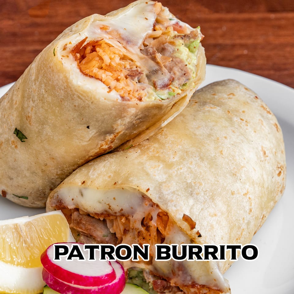 Two Patron burritos, one cut open to show rice, meat, and cheese, with a lemon wedge and radish.