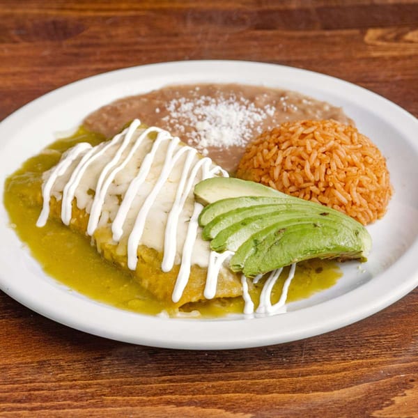 House of Tacos Grill's enchiladas with green sauce, sour cream, avocado, rice, and refried beans.