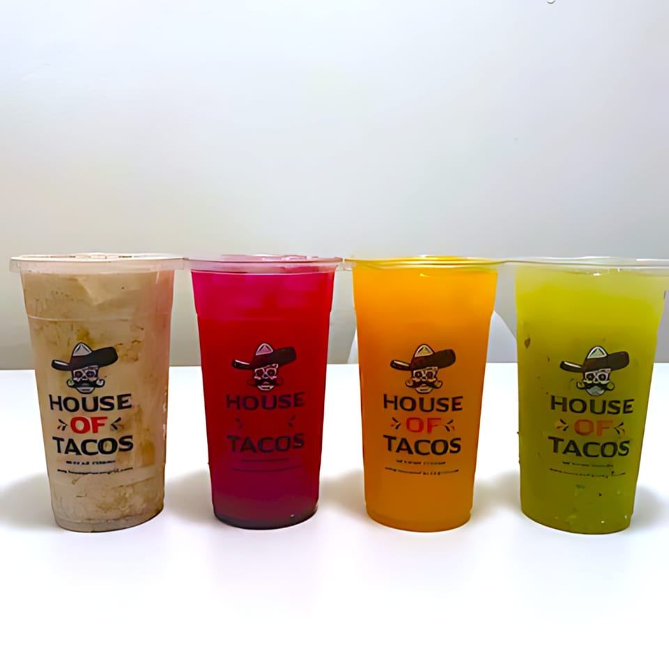 Four House of Tacos Grill drinks in clear cups: horchata, red, orange, and green beverages.